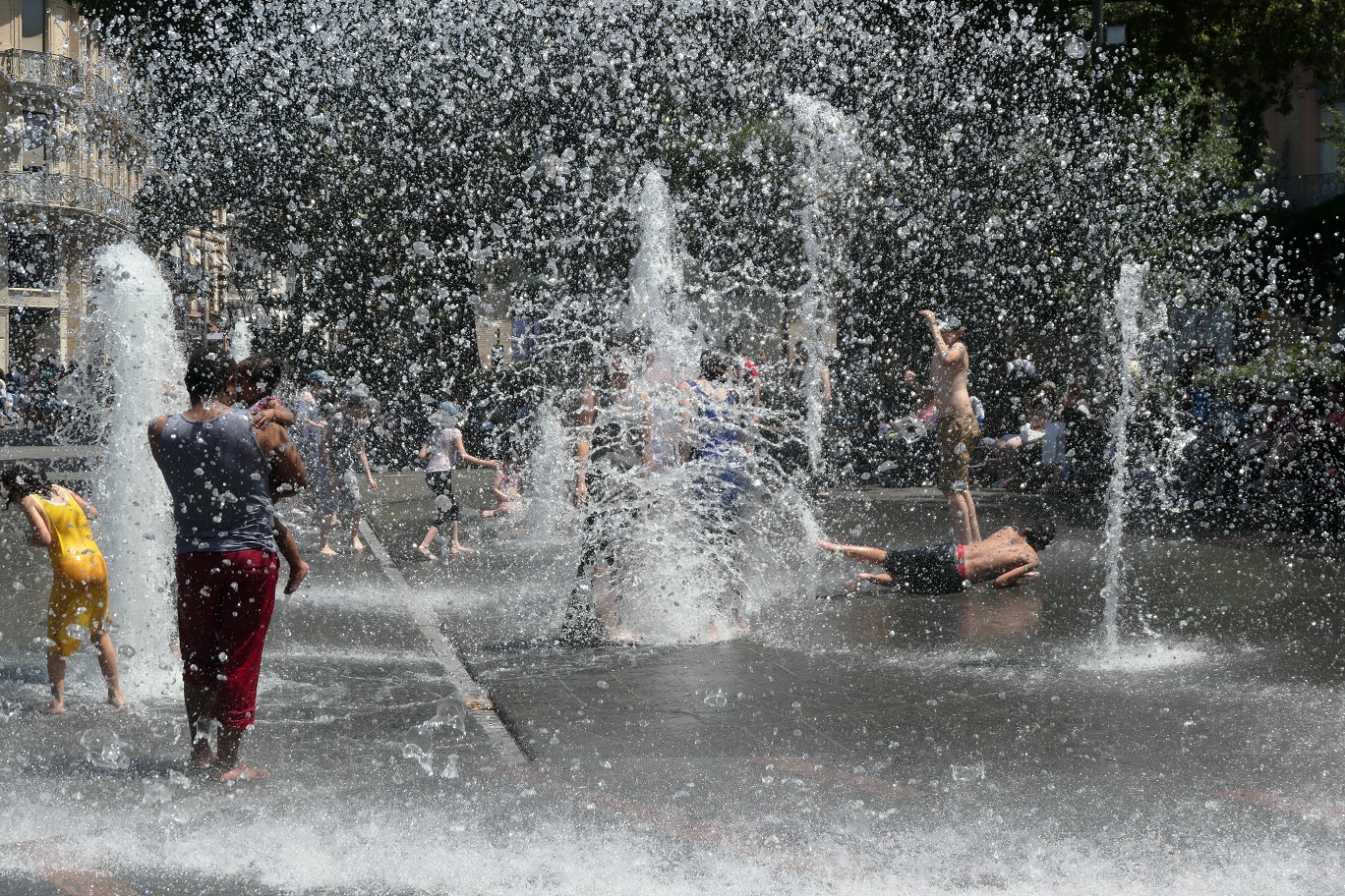 Children play in water park during heatwave